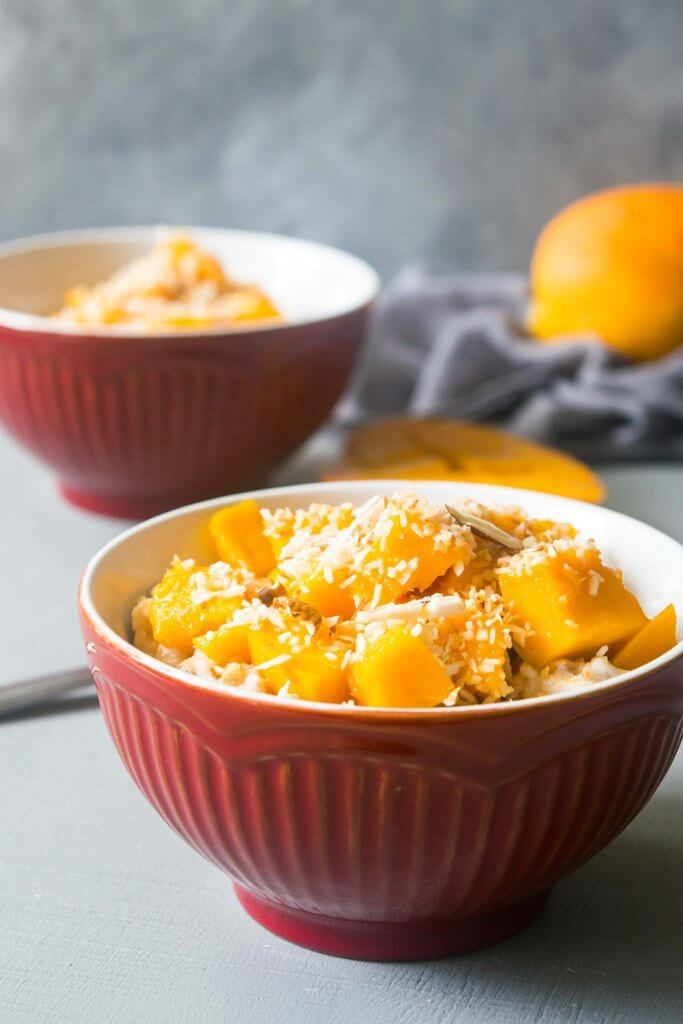 This vegan coconut mango oatmeal will transport you to a tropical paradise! This creamy oatmeal is a filling, healthy and incredibly delicious breakfast. | www.thelastcookie.ca