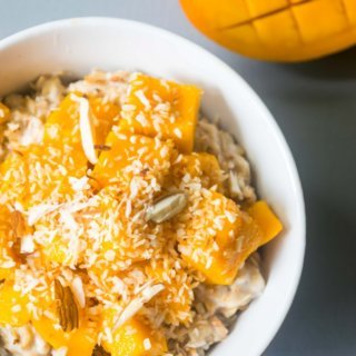 This vegan coconut mango oatmeal will transport you to a tropical paradise! This creamy oatmeal is a filling, healthy and incredibly delicious breakfast. | www.thelastcookie.ca