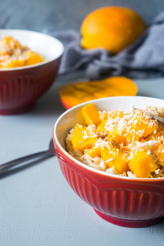 This vegan coconut mango oatmeal will transport you to a tropical paradise! This creamy oatmeal is a filling, healthy and incredibly delicious breakfast. | www.thelastcookie.ca