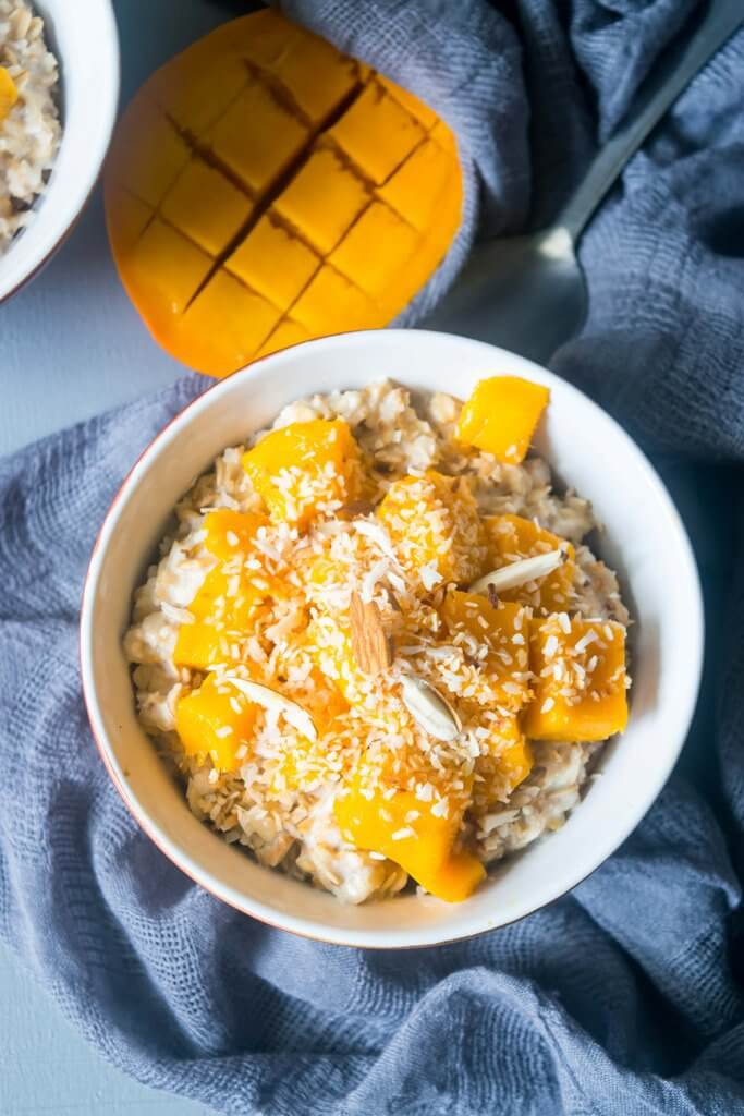 This vegan coconut mango oatmeal will transport you to a tropical paradise! This creamy oatmeal is a filling, healthy and incredibly delicious breakfast. | www.thelastcookie.ca