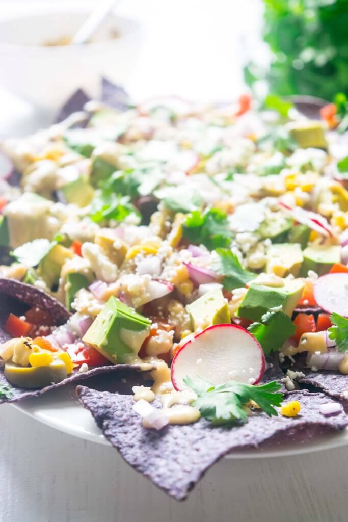 These Loaded Healthy Vegetarian Nachos pack in a punch with a lot of nutritious crunchy vegetables and a homemade cheese sauce. Light, amazingly delicious and just 30 minutes! |www.thelastcookie.ca