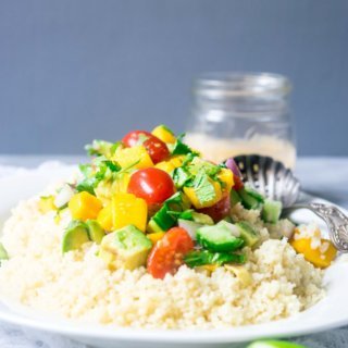 This incredible couscous salad is light and refreshing with sweet mangoes, cucumbers, summer vegetables and a spicy tahini dressing. A delicious blend of flavors for summers! | www.thelastcookie.ca