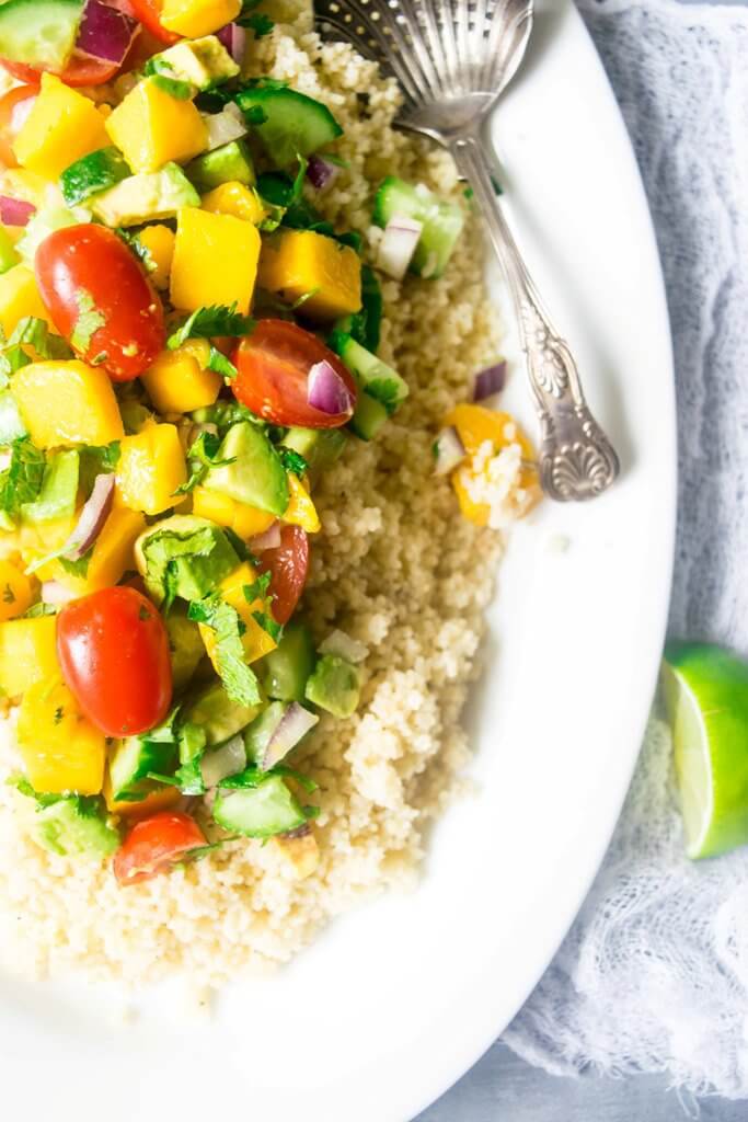 This incredible couscous salad is light and refreshing with sweet mangoes, cucumbers, summer vegetables and a spicy tahini dressing. A delicious blend of flavors for summers! | www.thelastcookie.ca