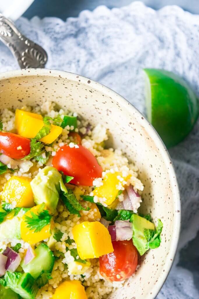 This incredible couscous salad is light and refreshing with sweet mangoes, cucumbers, summer vegetables and a spicy tahini dressing. A delicious blend of flavors for summers! | www.thelastcookie.ca